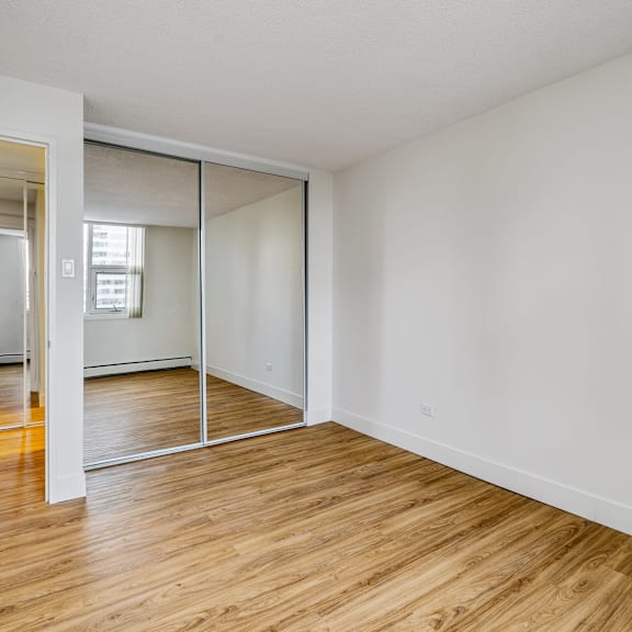 a room with a sliding door and wooden flooring.