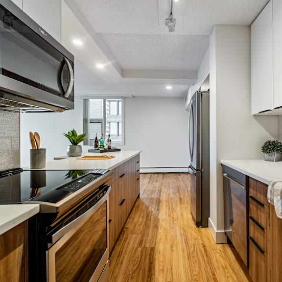 a modern kitchen with wooden cabinets and stainless steel appliances.
