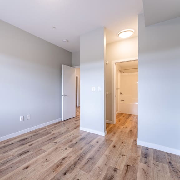 a room with a wooden floor and white walls.