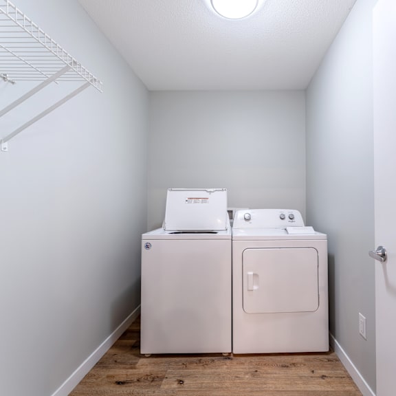 a white washer and dryer in a small laundry room.