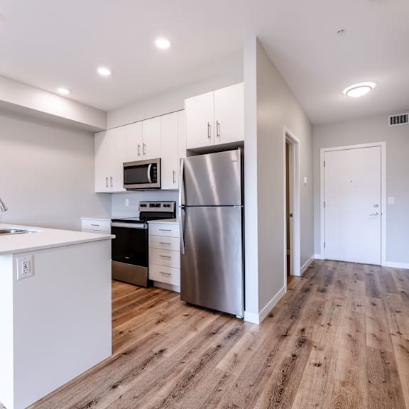 a modern kitchen with a refrigerator, oven, and microwave.
