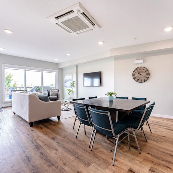 a modern dining room with a wooden table and chairs.