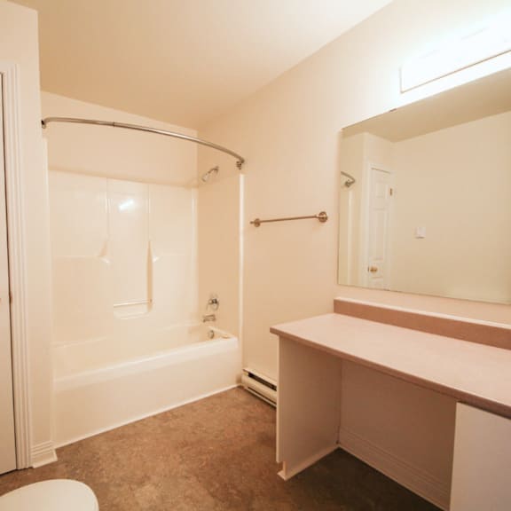 a white bathroom with a toilet, sink, and bathtub.