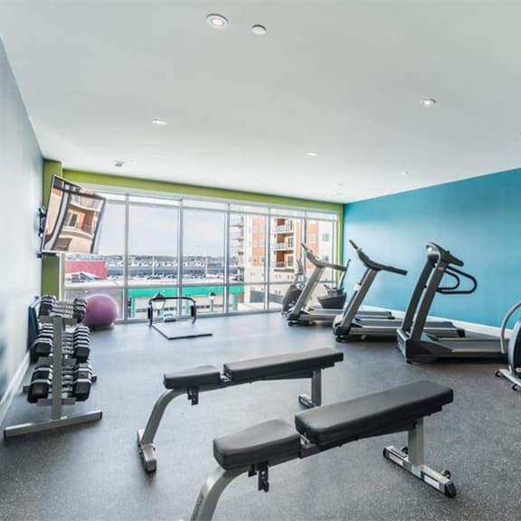 a gym with a view of the city.