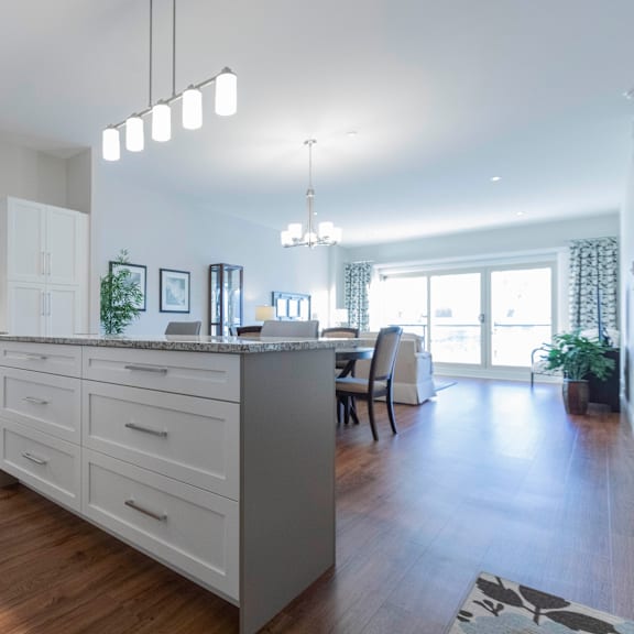 a modern kitchen with a large island and a dining area.