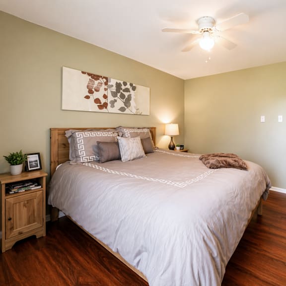 a bedroom with a large bed and a ceiling fan.