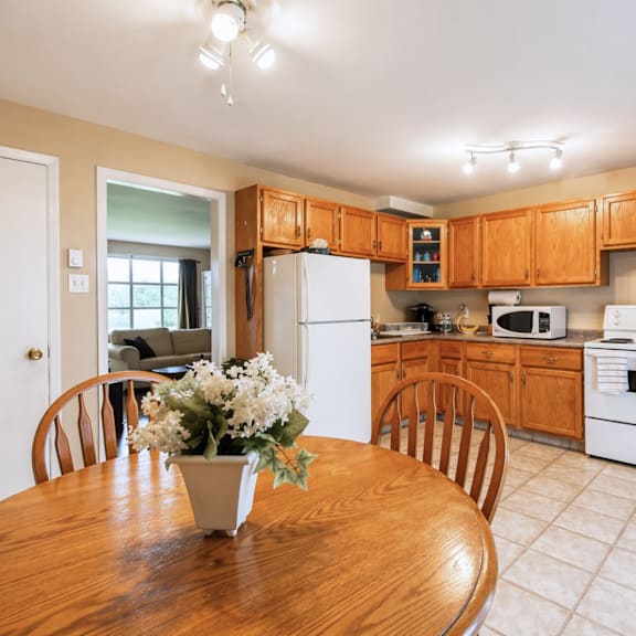 a kitchen with wooden cabinets and white appliances.
