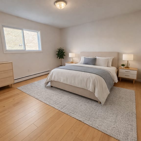 a bedroom with a large bed, a dresser, and a window.