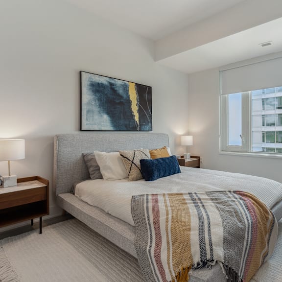 a bedroom with a large bed and a painting on the wall.