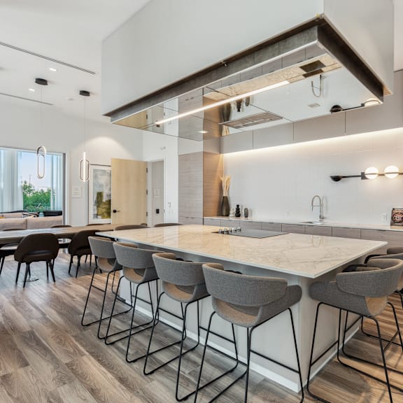 a modern kitchen with a large island and bar stools.