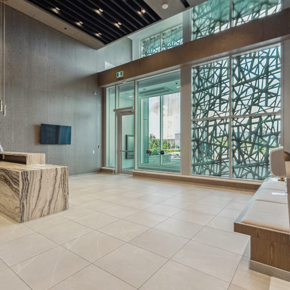 a reception area with a marble desk and a chair.
