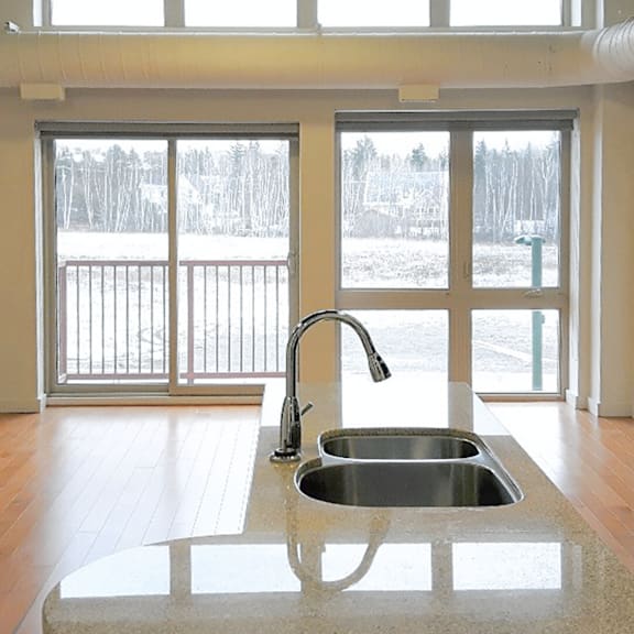 a kitchen sink with a faucet and a countertop.