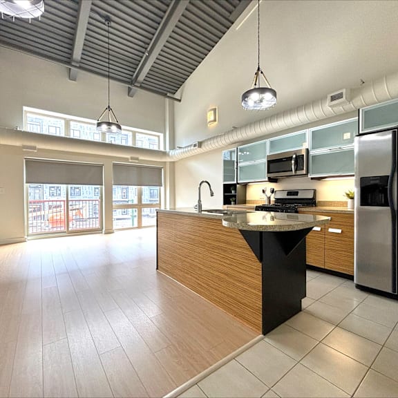 a kitchen with a black island in the middle of it.