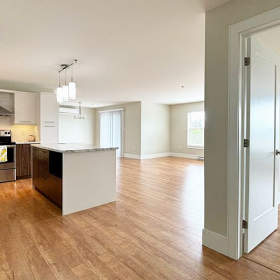 a kitchen with a black counter top and a white door.