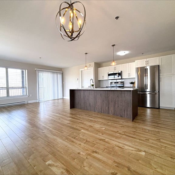 a kitchen with a wooden floor and a large island.