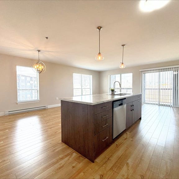 a kitchen with wooden floors and a large island with a sink.
