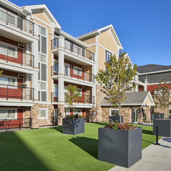 apartment complex with a green lawn in front.