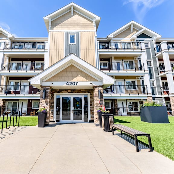 the image shows the front of apartment building number 4207 with a clear blue sky in the background.