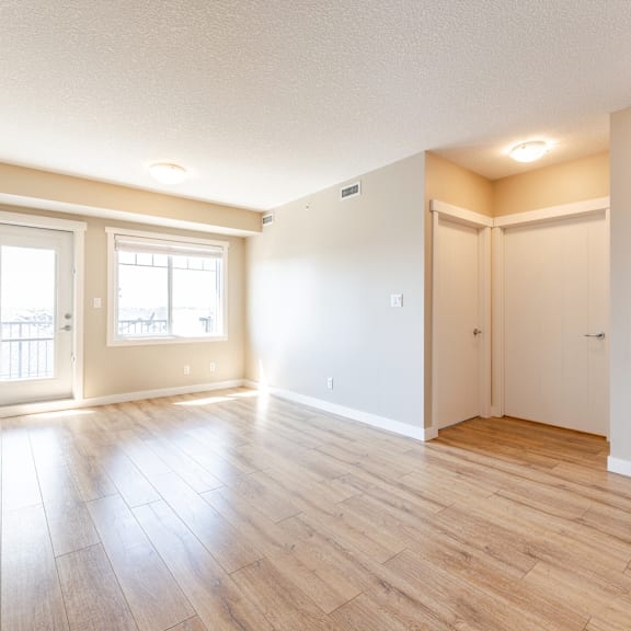 a room with wooden flooring and white walls.