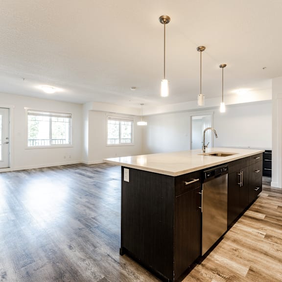 a kitchen with a large island and stainless steel appliances.