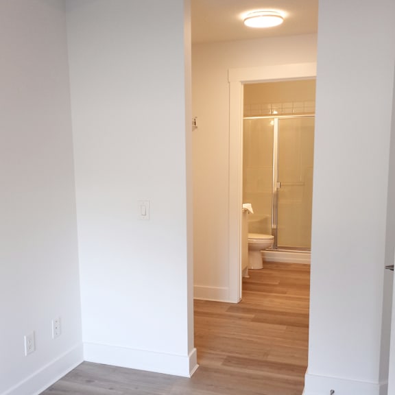a white bathroom with a glass shower door.