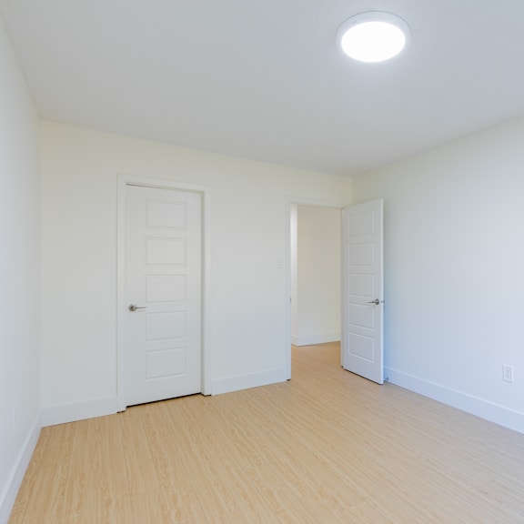 a room with two doors and a light on the ceiling.