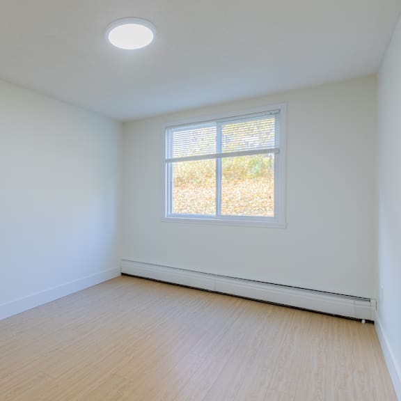 a room with a window and a light on the ceiling.