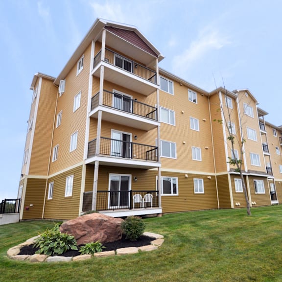 a large apartment building with a balcony on the second floor.