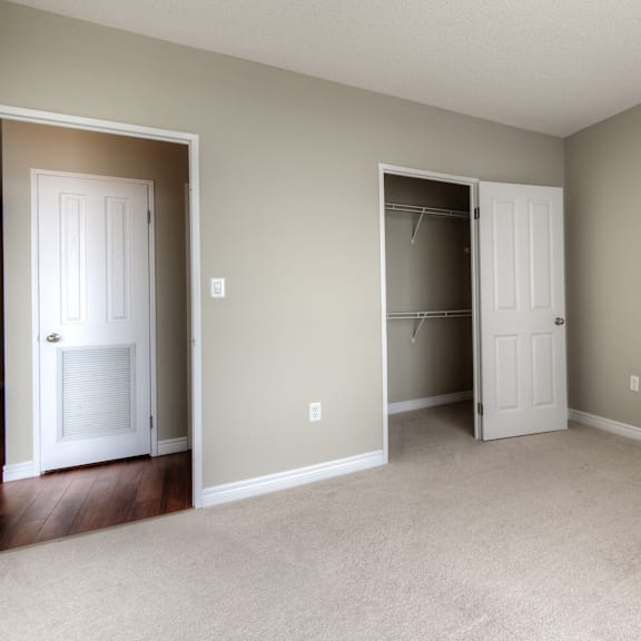a room with two white doors and a carpeted floor.