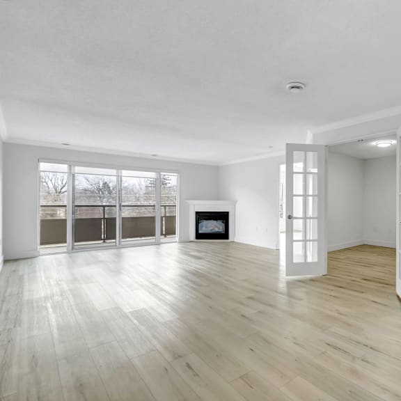 a spacious room with a fireplace and large windows.