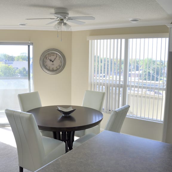 a dining room with a round table and four chairs.