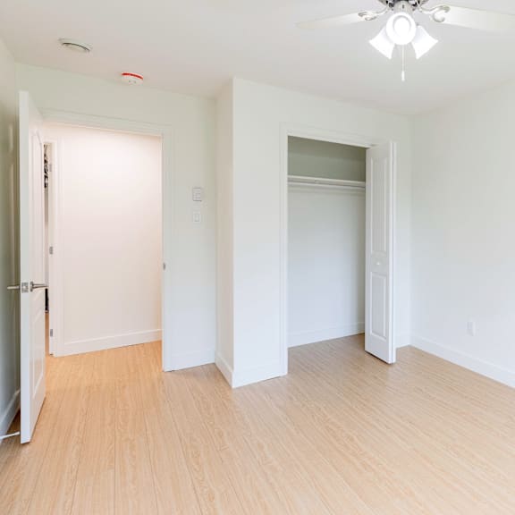 a room with a ceiling fan and light fixture.
