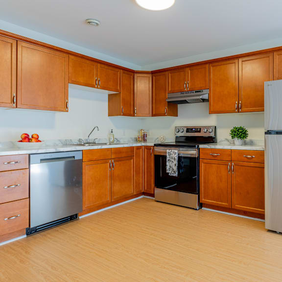 a kitchen with wooden cabinets and a white refrigerator.