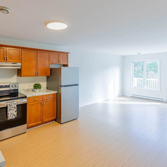 a kitchen with wooden cabinets and a refrigerator.