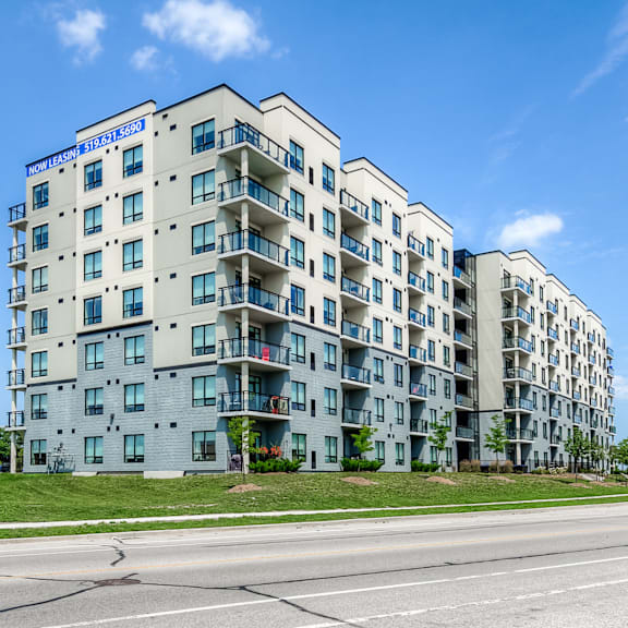 a modern apartment building with a blue sky in the background.
