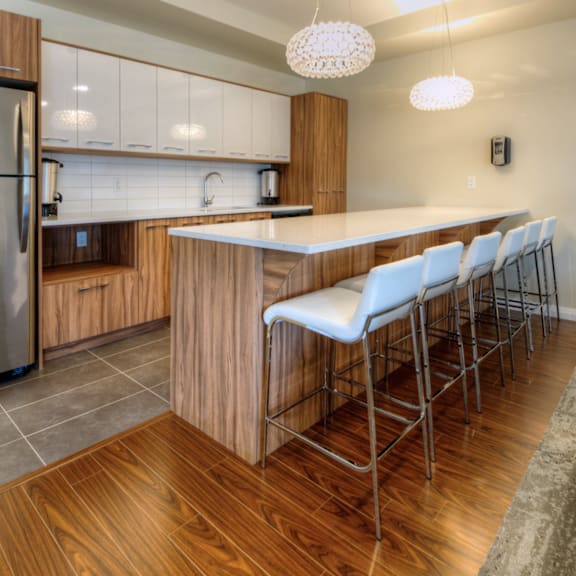 a modern kitchen with a large island and stainless steel appliances.
