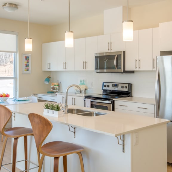 a kitchen with white cabinets and a white countertop.