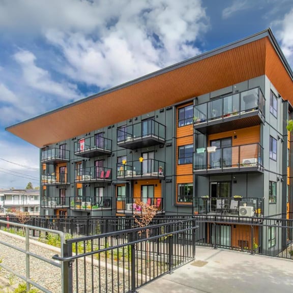 a modern building with black and orange exterior and balconies.