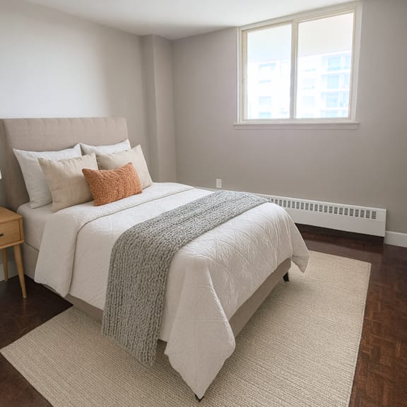 a bedroom with a large bed and a window.