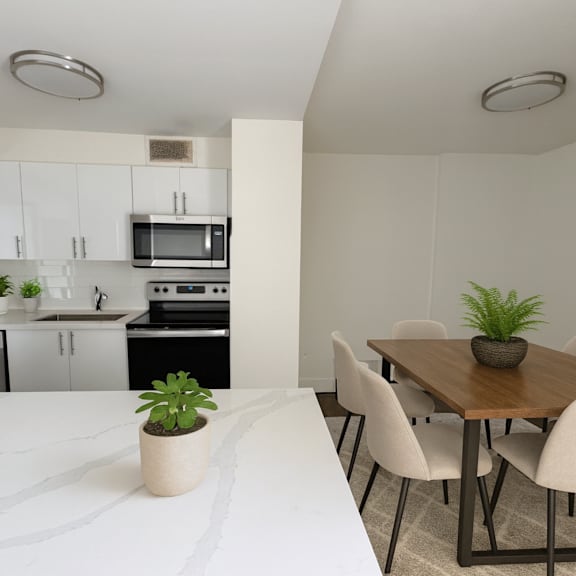 a kitchen with a dining table and chairs.