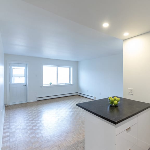 a kitchen with a black countertop and white cabinets.
