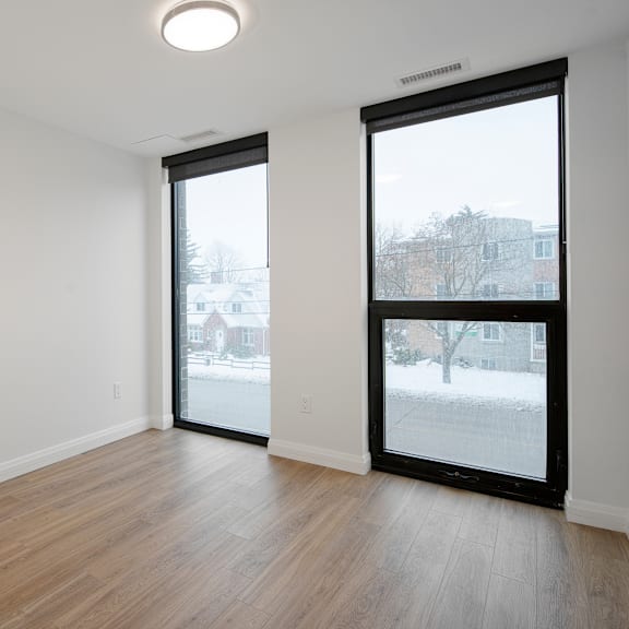 a room with a sliding door and a window showing a snowy landscape outside.
