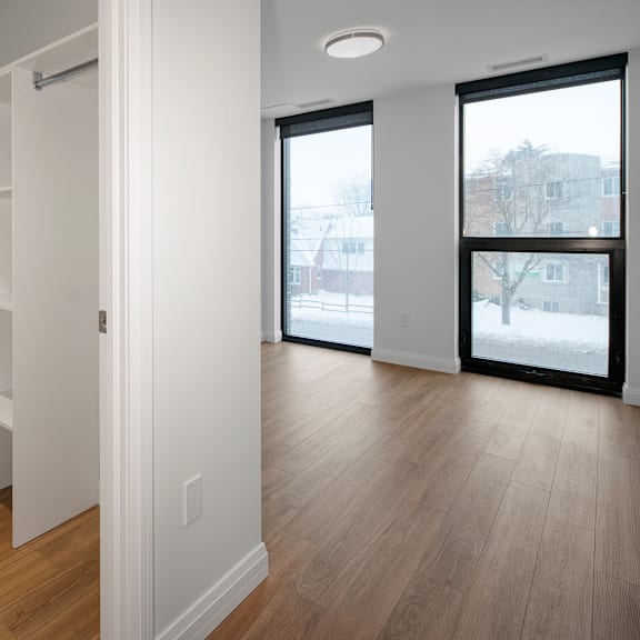 a white room with a sliding door leading to a balcony.