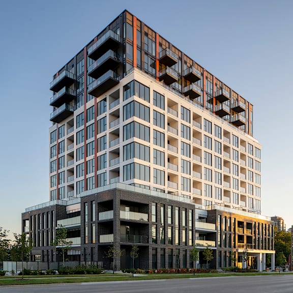 a modern multi-story building with balconies on the upper floors.