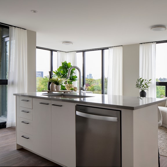 a modern kitchen with a large window overlooking the city.
