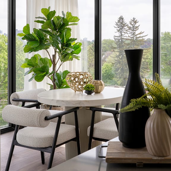 a table with a vase and a plant on it.