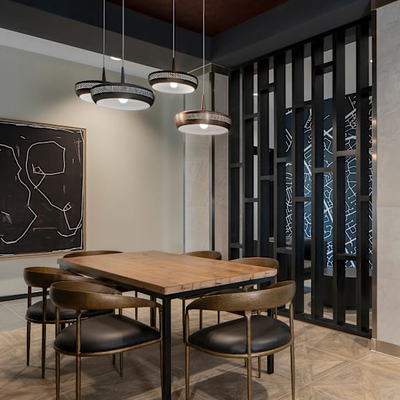 a dining room with a wooden table and chairs.