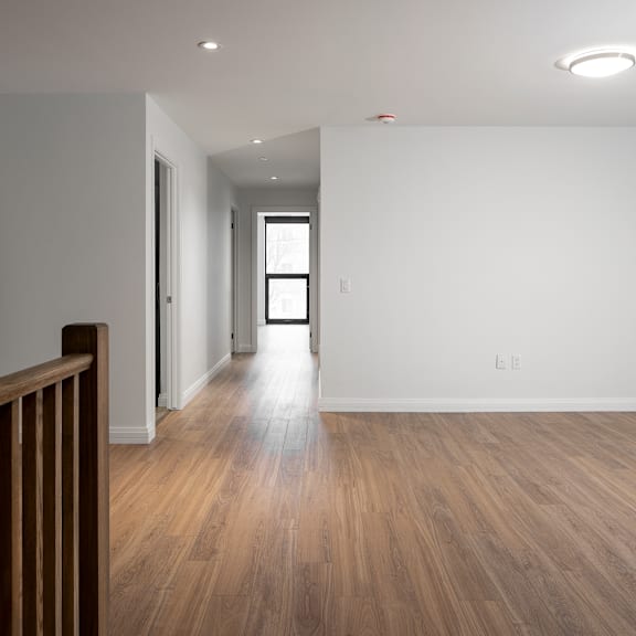 a room with wooden flooring and white walls.