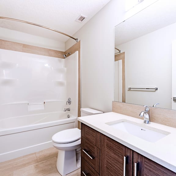 a white toilet sits next to a sink in a bathroom.