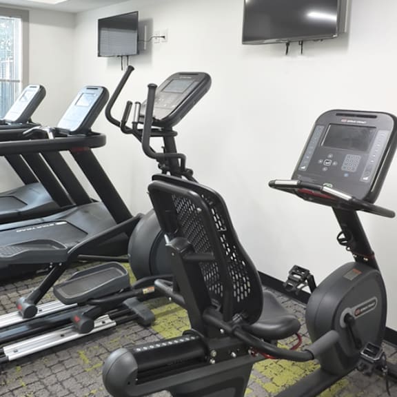 a gym with treadmills and exercise bikes.
